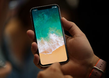 iPhone X with Status Bar in Hand Free Mockup