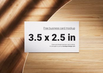 Business Cards Lying on a Wooden Table Free Mockups