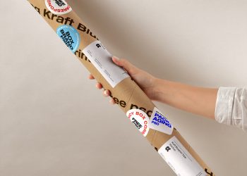 Hand Holding Kraft Tube Free Mockup